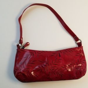 Red leather purse with botanical detail